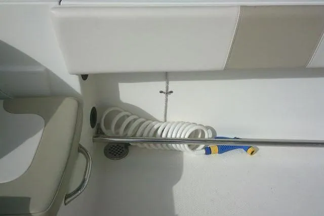 Slide: The Image of 2016 Robalo R200 Center Console boat interior with coiled hose and seating. - 47