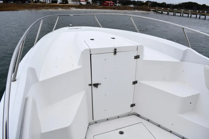 Slide: The Image of 2001 Fountain 31 Tournament Edition boat deck with storage compartment, dockside view. - 10