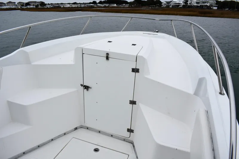 Slide: The Image of 2001 Fountain 31 Tournament Edition boat bow with storage compartment, docked near shoreline. - 11