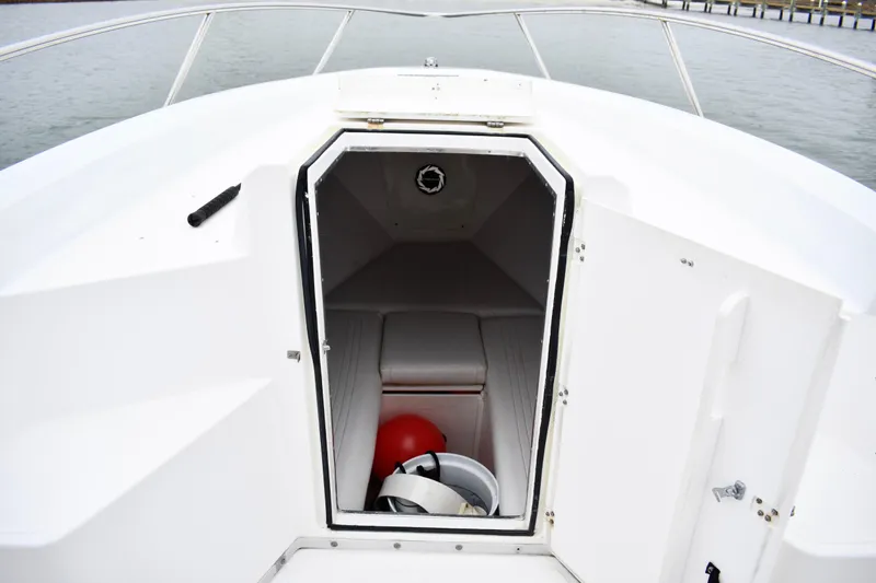 Slide: The Image of 2001 Fountain 31 Tournament Edition boat cabin with open hatch, revealing interior storage. - 12