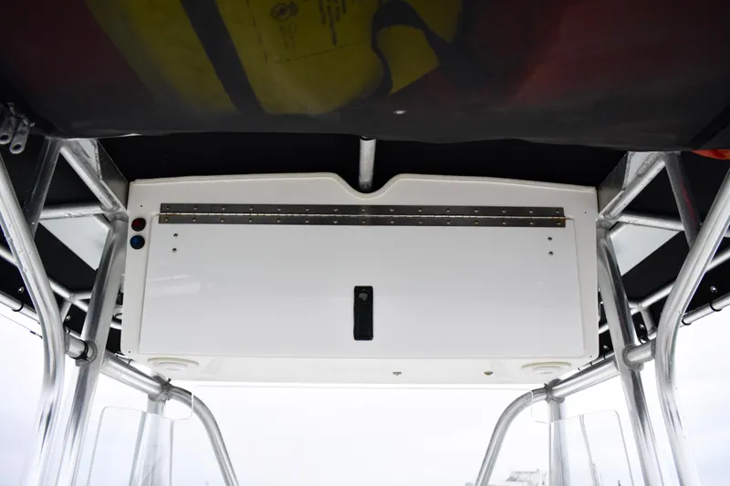 Slide: The Image of 2001 Fountain 31 Tournament Edition boat console with storage compartment and metal framework. - 23