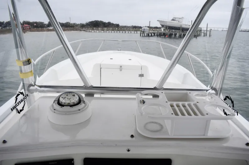 Slide: The Image of 2001 Fountain 31 Tournament Edition boat dashboard with compass and cup holders. - 24