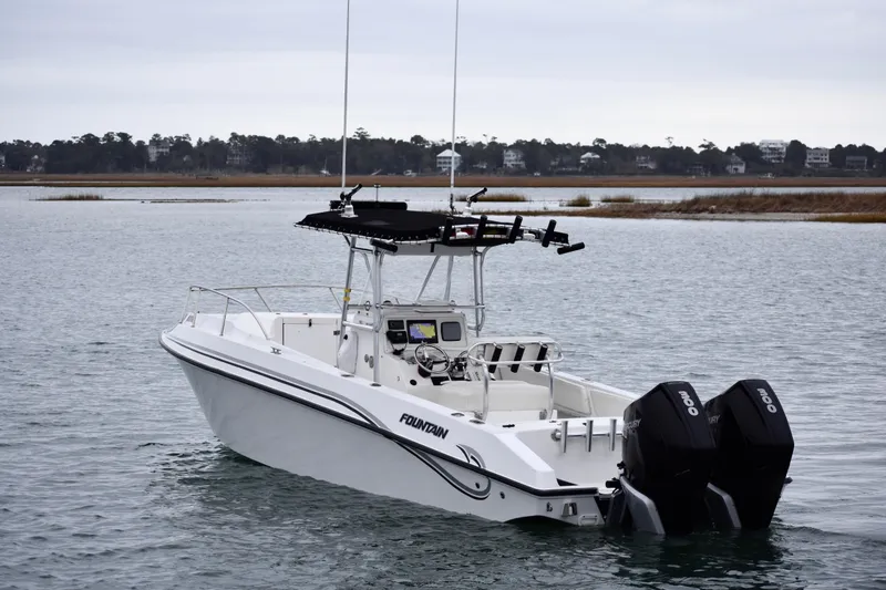 Slide: The Image of 2001 Fountain 31 Tournament Edition boat on calm water with twin outboard motors. - 3