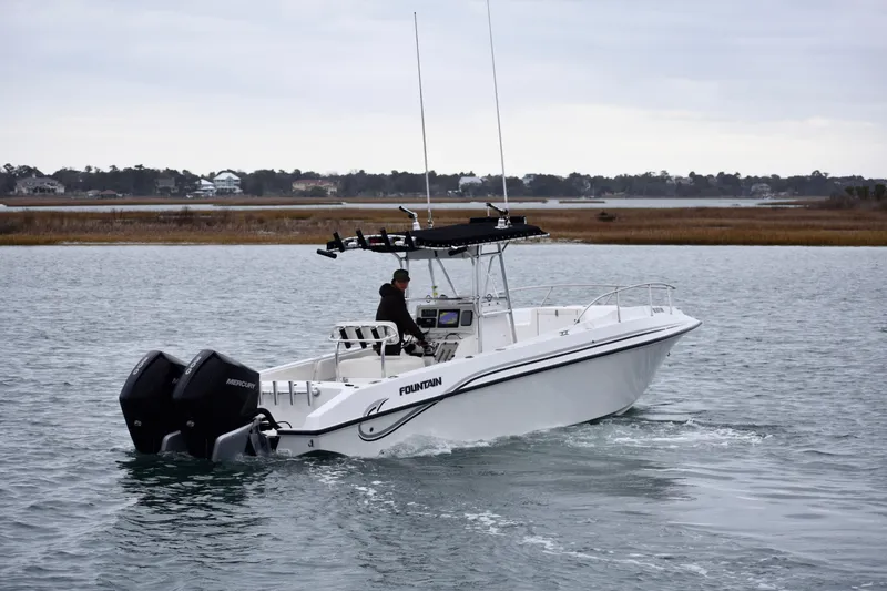 Slide: The Image of 2001 Fountain 31 Tournament Edition boat cruising on a calm waterway. - 5