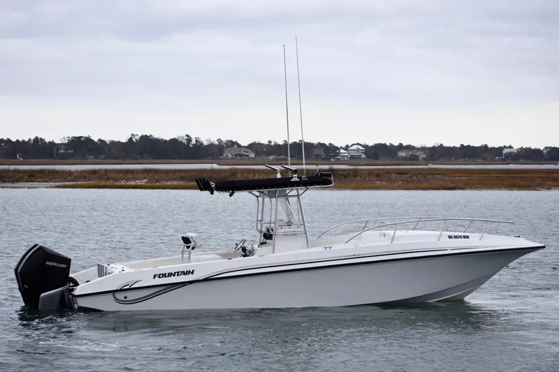 Slide: The Image of 2001 Fountain 31 Tournament Edition boat on calm water, side view. - 6
