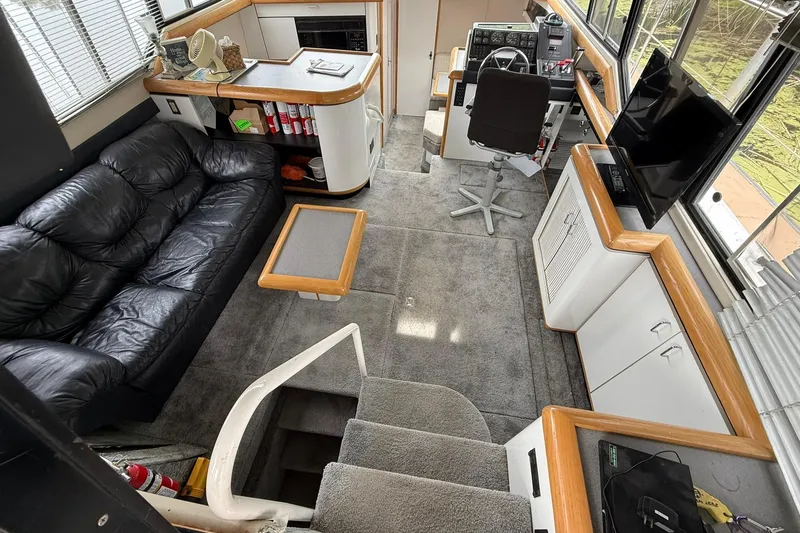 Slide: The Image of Interior of 1991 Bayliner 4387 Motoryacht with leather sofa, helm, and TV. - 13
