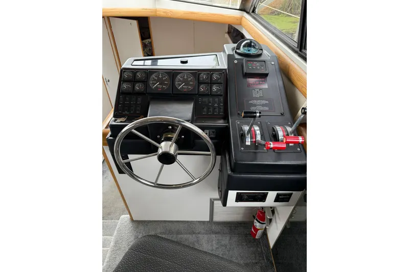 Slide: The Image of 1991 Bayliner 4387 Motoryacht helm with steering wheel, gauges, and controls. - 14