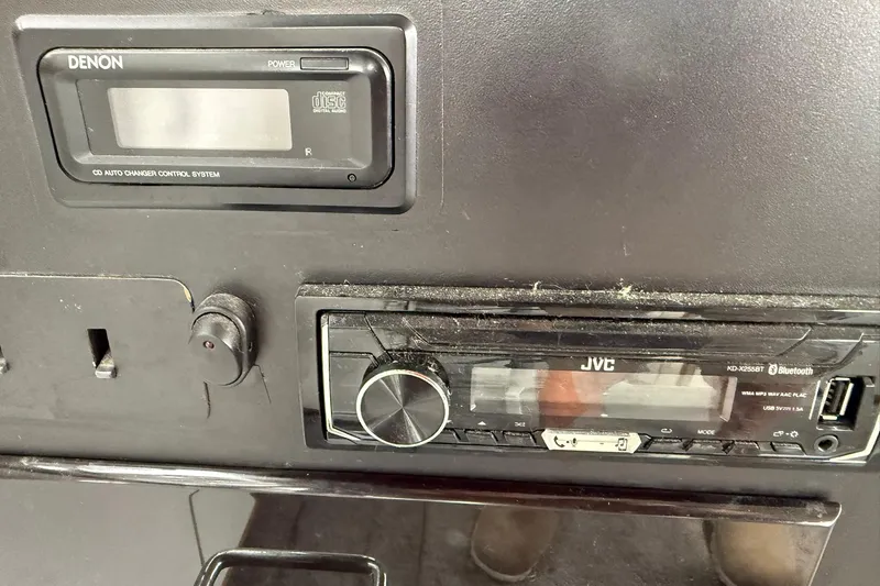 Slide: The Image of 1991 Bayliner 4387 Motoryacht dashboard with Denon and JVC audio systems. - 16