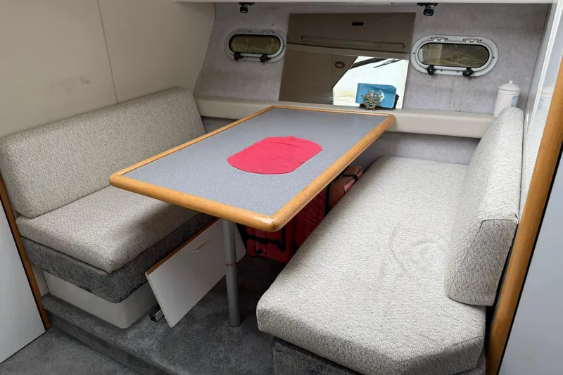 Slide: The Image of Interior of 1991 Bayliner 4387 Motoryacht with dining area and cushioned seating. - 17