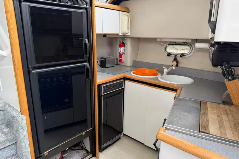 Slide: The Image of 1991 Bayliner 4387 Motoryacht kitchen with appliances, sink, and countertop. - 18