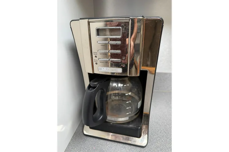 Slide: The Image of Mr. Coffee machine on countertop, featuring programmable settings and glass carafe. - 24