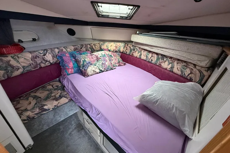 Slide: The Image of Cozy bedroom in 1991 Bayliner 4387 Motoryacht with floral decor and purple bedding. - 26