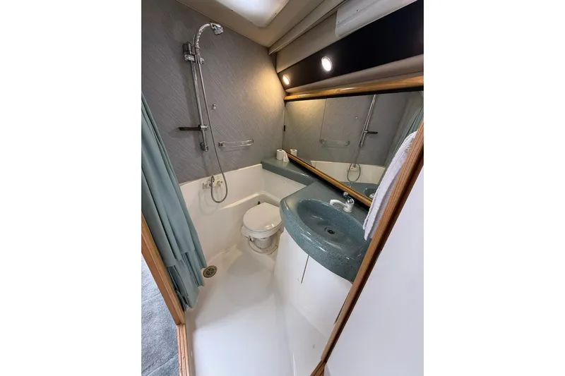 Slide: The Image of Bathroom interior of 1991 Bayliner 4387 Motoryacht with shower, sink, and toilet. - 27