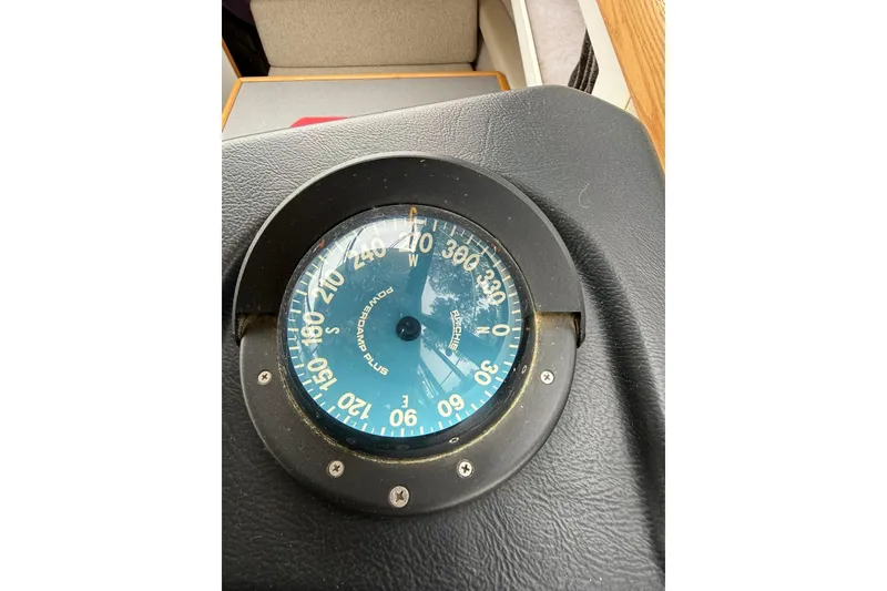 Slide: The Image of Compass on 1991 Bayliner 4387 Motoryacht dashboard, showing cardinal directions. - 29