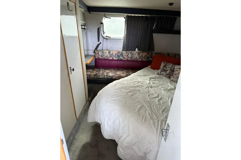 Slide: The Image of Cozy bedroom interior of 1991 Bayliner 4387 Motoryacht with bed and seating area. - 33