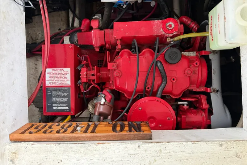 Slide: The Image of Engine compartment of a 1991 Bayliner 4387 Motoryacht with red machinery and warning label. - 39