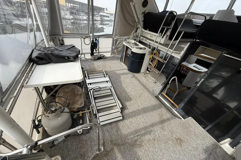 Slide: The Image of 1991 Bayliner 4387 Motoryacht interior with carpeted deck and equipment storage. - 4
