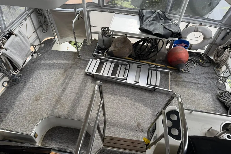 Slide: The Image of 1991 Bayliner 4387 Motoryacht deck with equipment and accessories, featuring a ladder and ropes. - 6