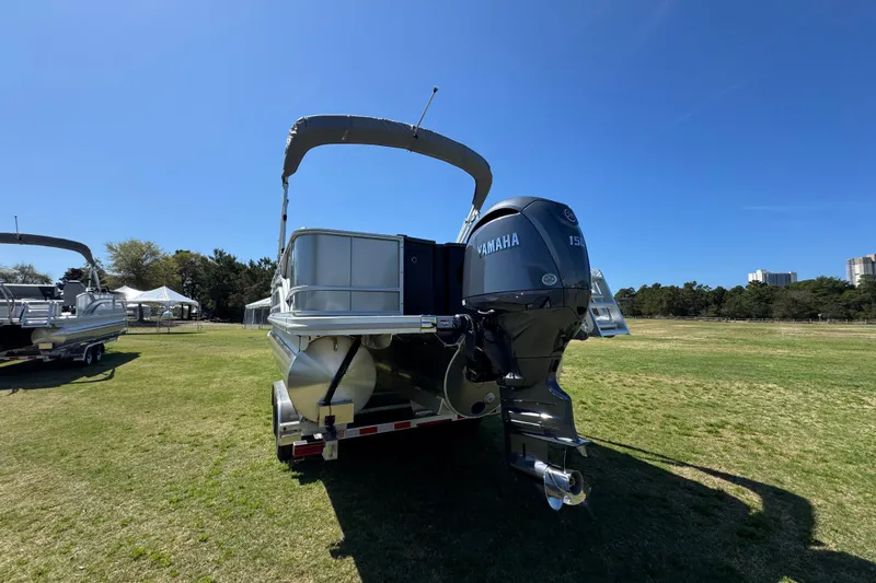 Slide: The Image of 2026 Bennington 22 S Fish pontoon boat with Yamaha outboard motor on grassy field. - 11