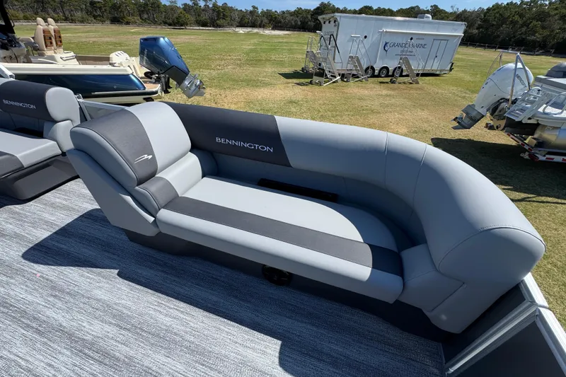 Slide: The Image of 2026 Bennington 22 S Fish boat interior with gray seating on display outdoors. - 15