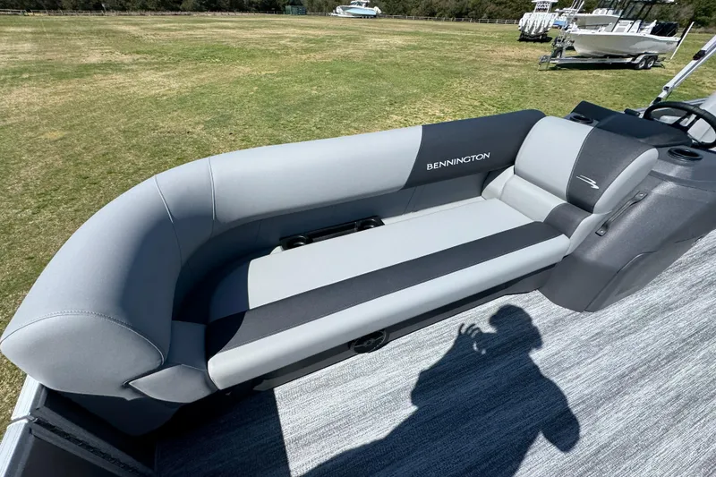Slide: The Image of 2026 Bennington 22 S Fish boat seat, gray upholstery, outdoor setting. - 16