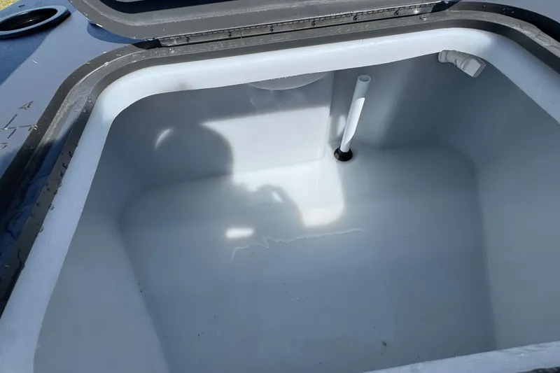 Slide: The Image of Open storage compartment in 2026 Bennington 22 S Fish boat, featuring a clean interior. - 22