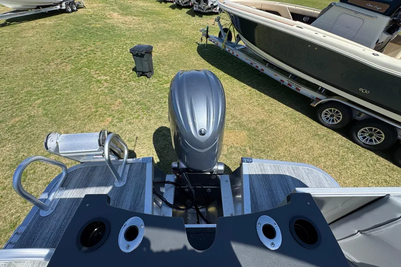 Slide: The Image of 2026 Bennington 22 S Fish boat with outboard motor, viewed from above on grassy area. - 24