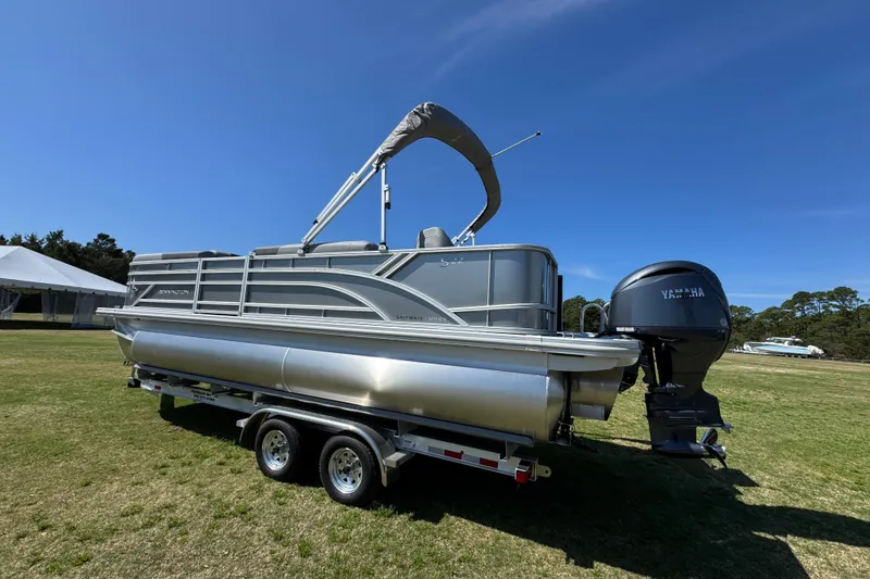 Slide: The Image of 2026 Bennington 22 S Fish pontoon boat on trailer, displayed outdoors. - 8