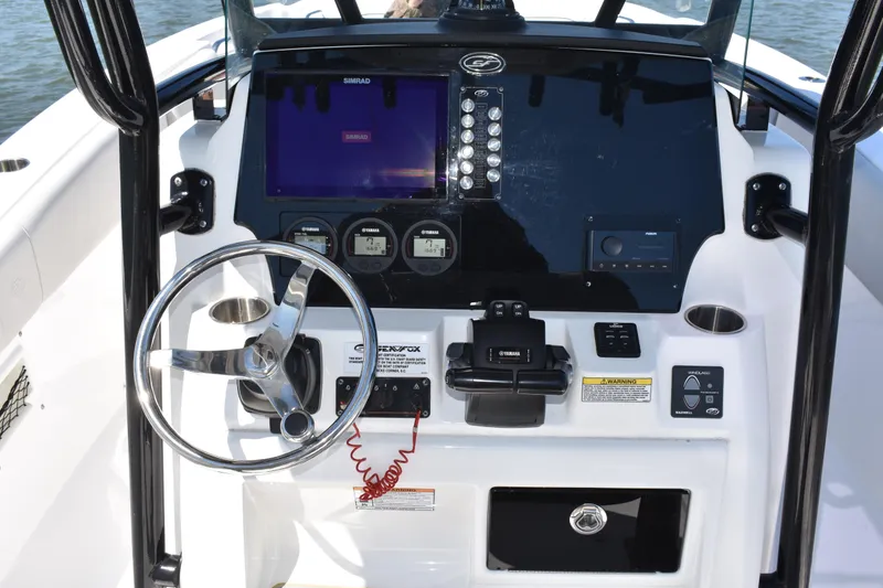 Slide: The Image of 2021 Sea Fox 268 Commander boat dashboard with steering wheel and navigation controls. - 34