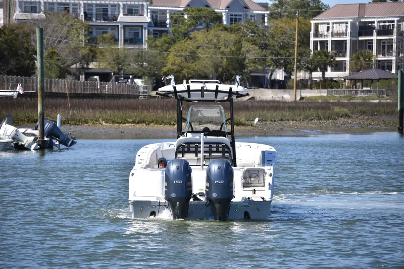Slide: The Image of 2021 Sea Fox 268 Commander boat navigating calm waters near residential area. - 5