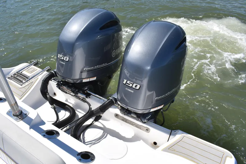 Slide: The Image of Twin Yamaha 150 engines on a 2021 Sea Fox 268 Commander boat in water. - 53