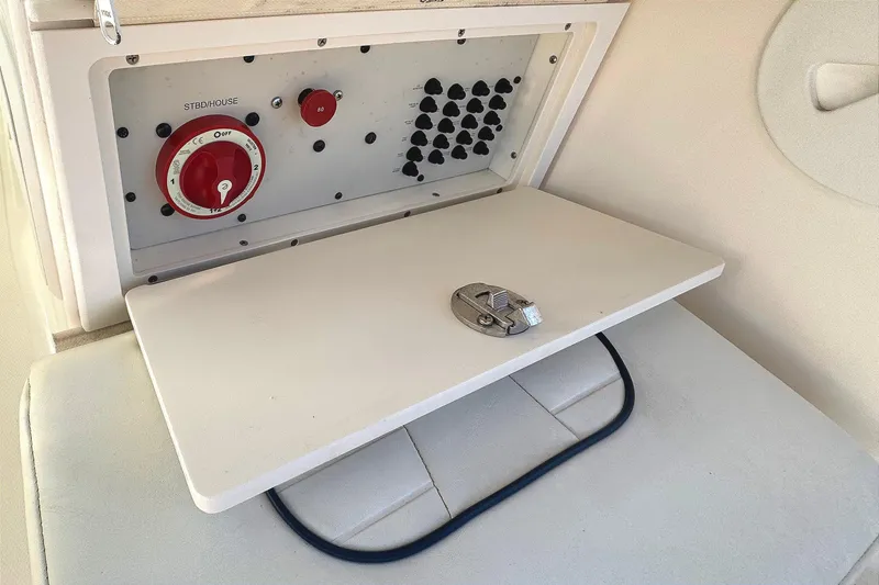 Slide: The Image of Control panel on a 2014 Wellcraft 252 Coastal boat, featuring switches and a red dial. - 16