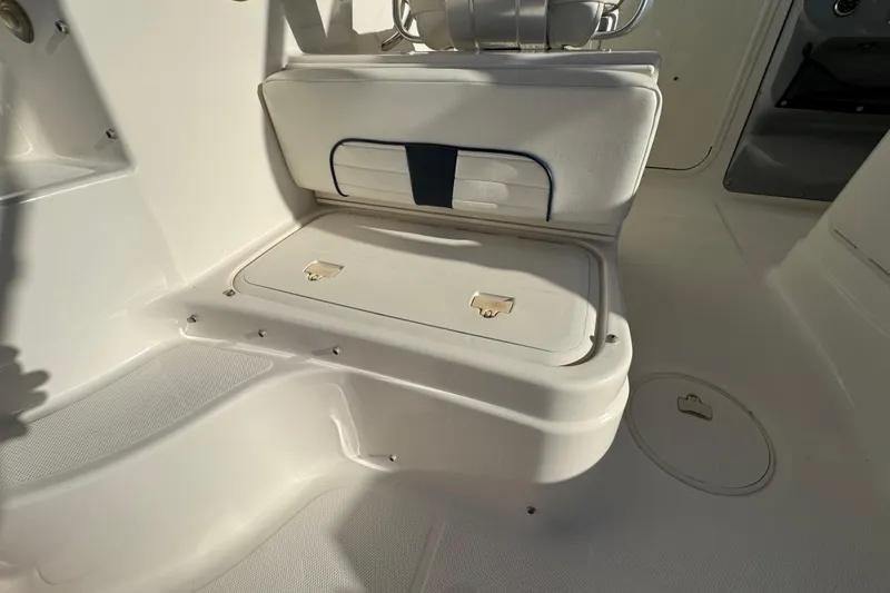 Slide: The Image of 2014 Wellcraft 252 Coastal boat interior with seating and storage compartments. - 18