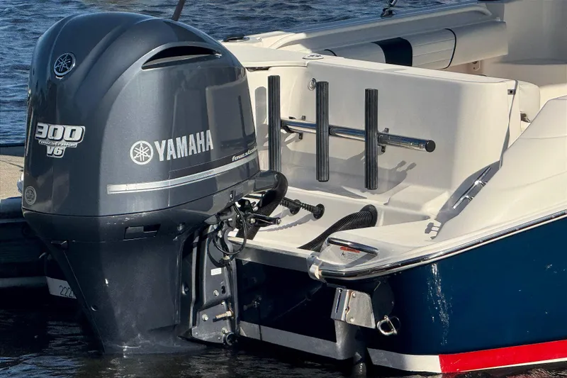 Slide: The Image of 2014 Wellcraft 252 Coastal boat with Yamaha 300 V6 outboard motor on water. - 2