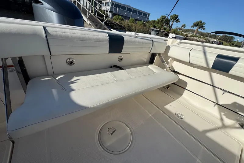 Slide: The Image of 2014 Wellcraft 252 Coastal boat interior with white seating and storage compartments. - 22