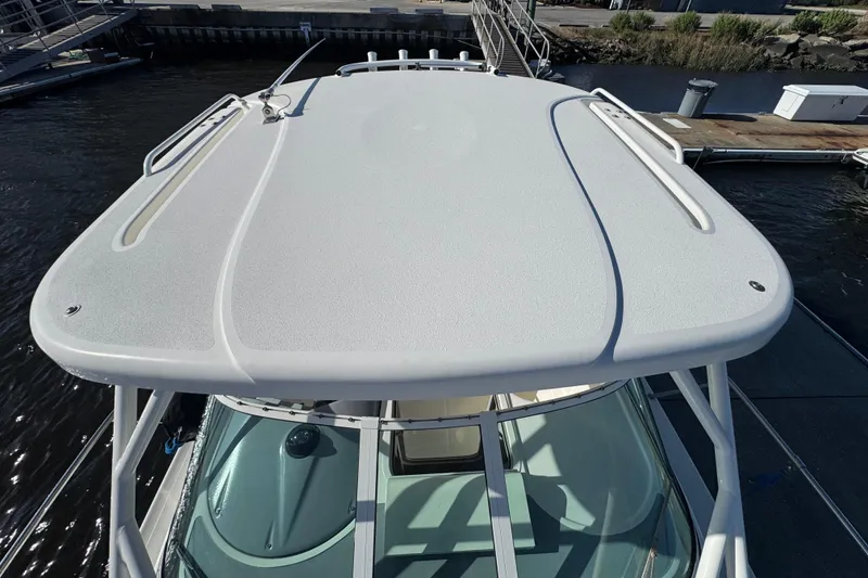 Slide: The Image of 2014 Wellcraft 252 Coastal boat roof view at dockside. - 7