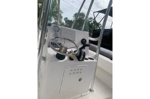 Slide: The Image of 2016 Sundance B22CCR boat console with steering wheel and controls. - 3