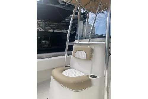 Slide: The Image of 2016 Sundance B22CCR boat interior with beige and white seating. - 4
