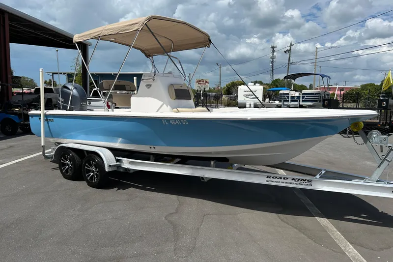 The Image of 2020 Tidewater 2110 Bay Max boat on trailer, blue hull, parked outdoors. - 1