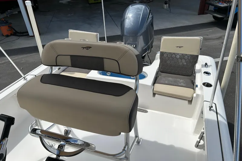 Slide: The Image of 2020 Tidewater 2110 Bay Max boat interior with seating and motor. - 11