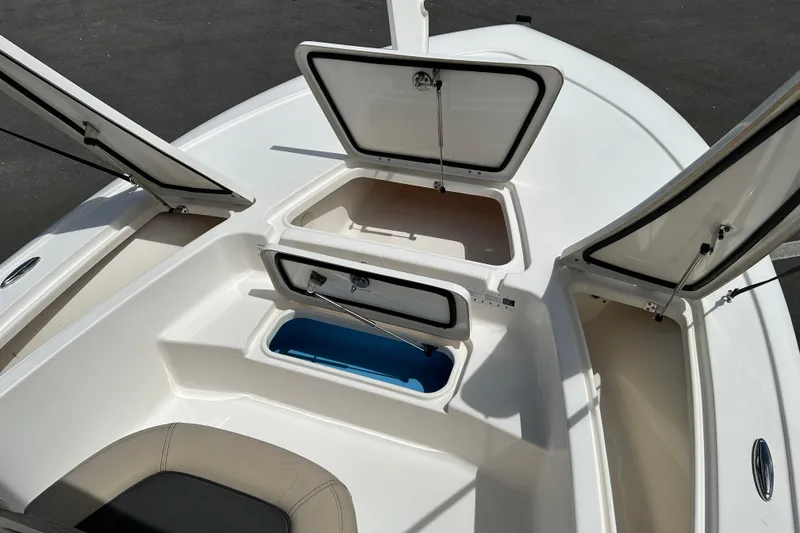Slide: The Image of 2020 Tidewater 2110 Bay Max boat storage compartments open on deck. - 13