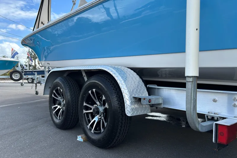 Slide: The Image of 2020 Tidewater 2110 Bay Max boat on trailer with dual wheels, blue hull. - 16