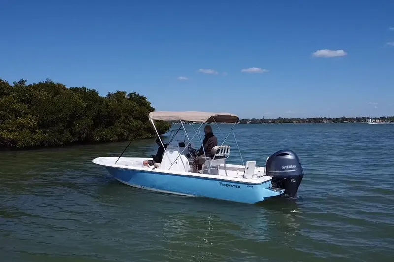 Slide: The Image of 2020 Tidewater 2110 Bay Max boat on calm water with canopy and Yamaha engine. - 18