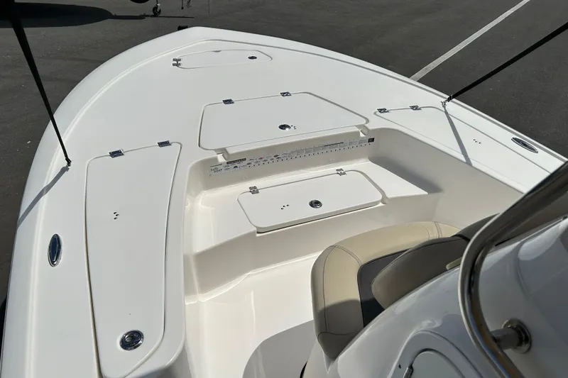 Slide: The Image of 2020 Tidewater 2110 Bay Max boat interior with storage compartments and seating. - 8