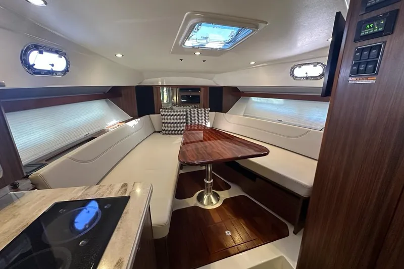Slide: The Image of Luxurious interior of 2020 Pursuit OS 355 Offshore yacht with elegant seating and wooden table. - 18
