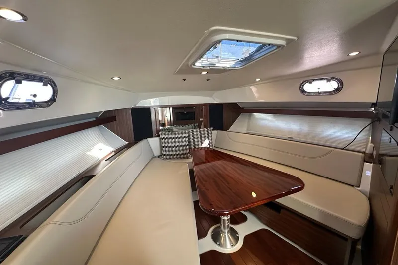 Slide: The Image of Luxurious interior of 2020 Pursuit OS 355 Offshore yacht with elegant seating and wooden table. - 19