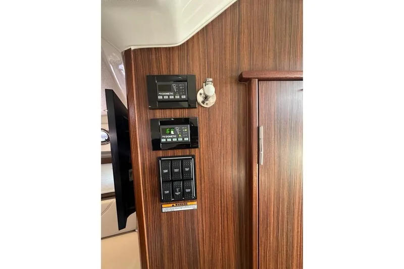 Slide: The Image of Control panel on 2020 Pursuit OS 355 Offshore boat with wood finish interior. - 22