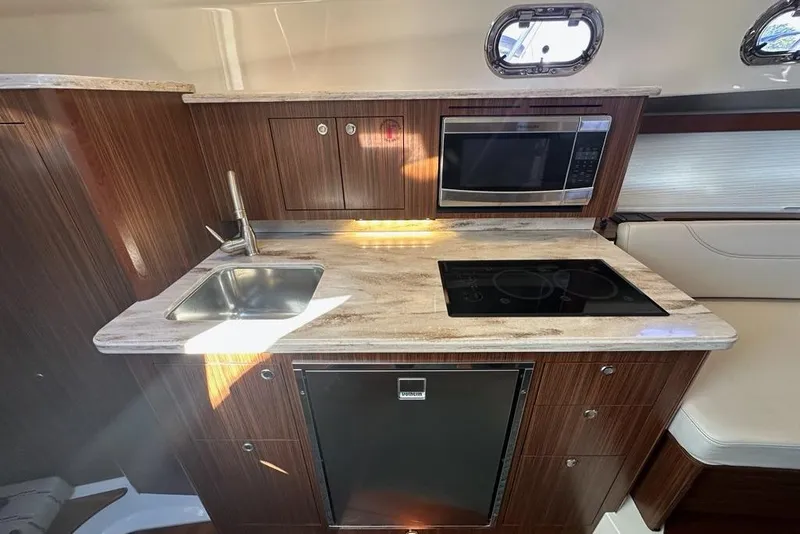 Slide: The Image of Modern kitchen in 2020 Pursuit OS 355 Offshore boat with sink, stove, and microwave. - 24
