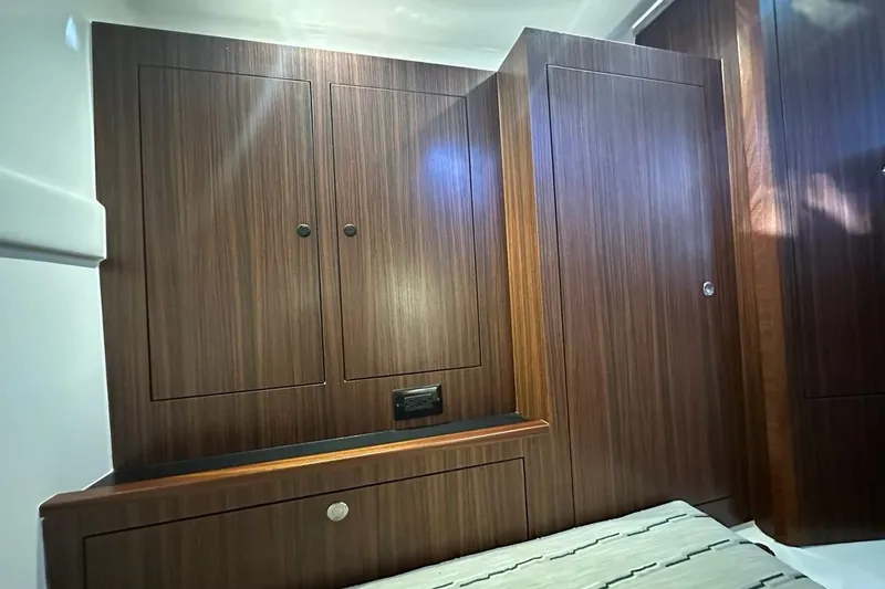 Slide: The Image of 2020 Pursuit OS 355 Offshore cabin interior with wooden cabinetry and modern design. - 29