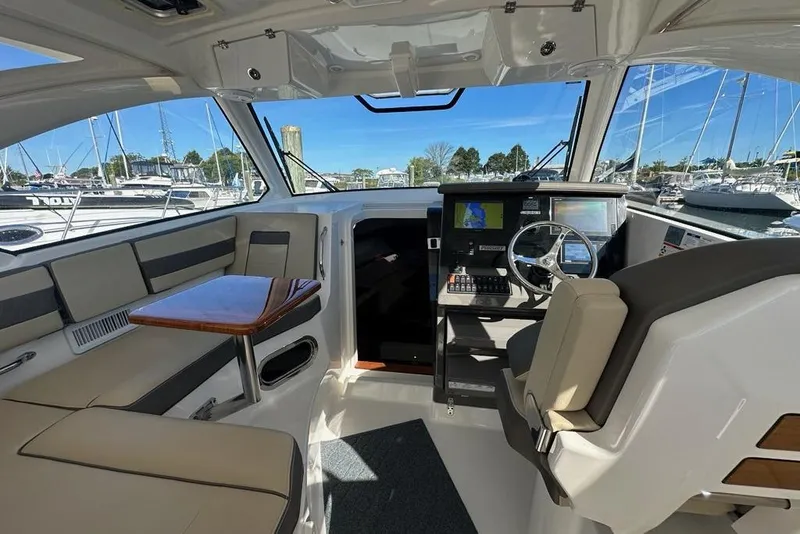 Slide: The Image of 2020 Pursuit OS 355 Offshore boat interior with helm, seating, and navigation equipment. - 3